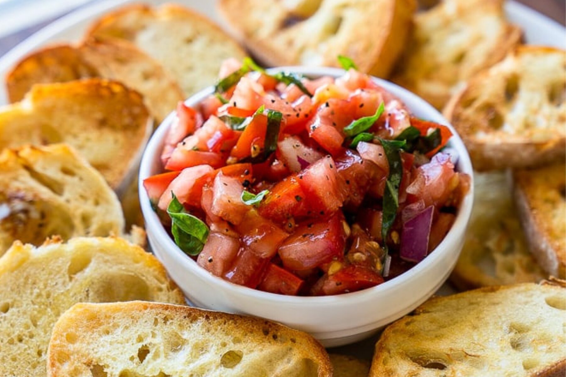 Bruschetta dip of tomatoes, basil and garlic served with toasted baguette slices