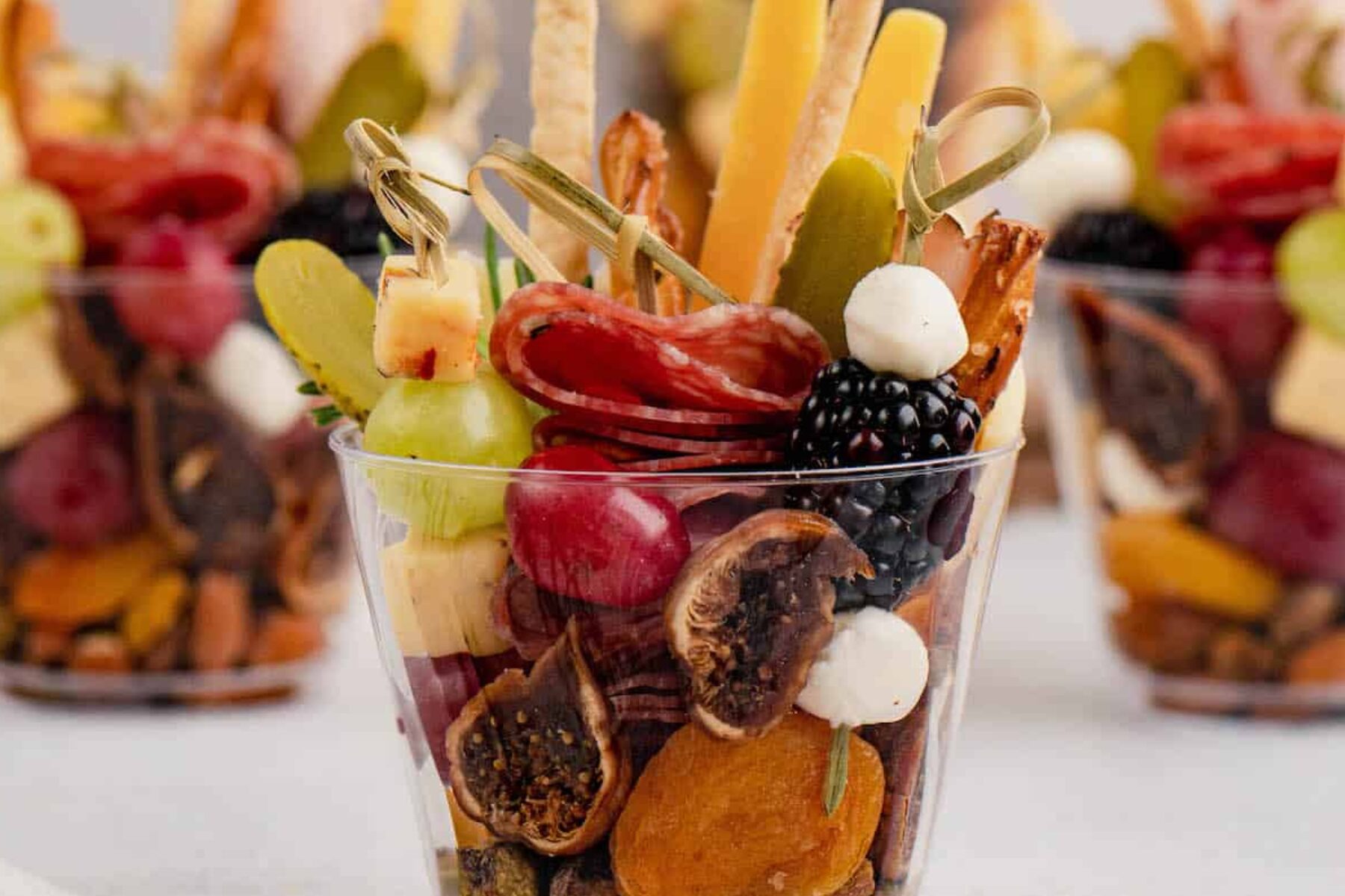 Charcuterie mini cups with artisan cheese, meats, olives and seasonal fruit